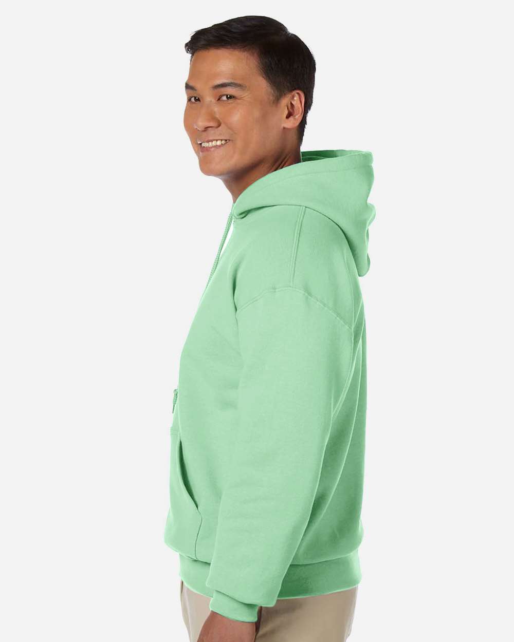 Man wearing a light green hoodie on a white background