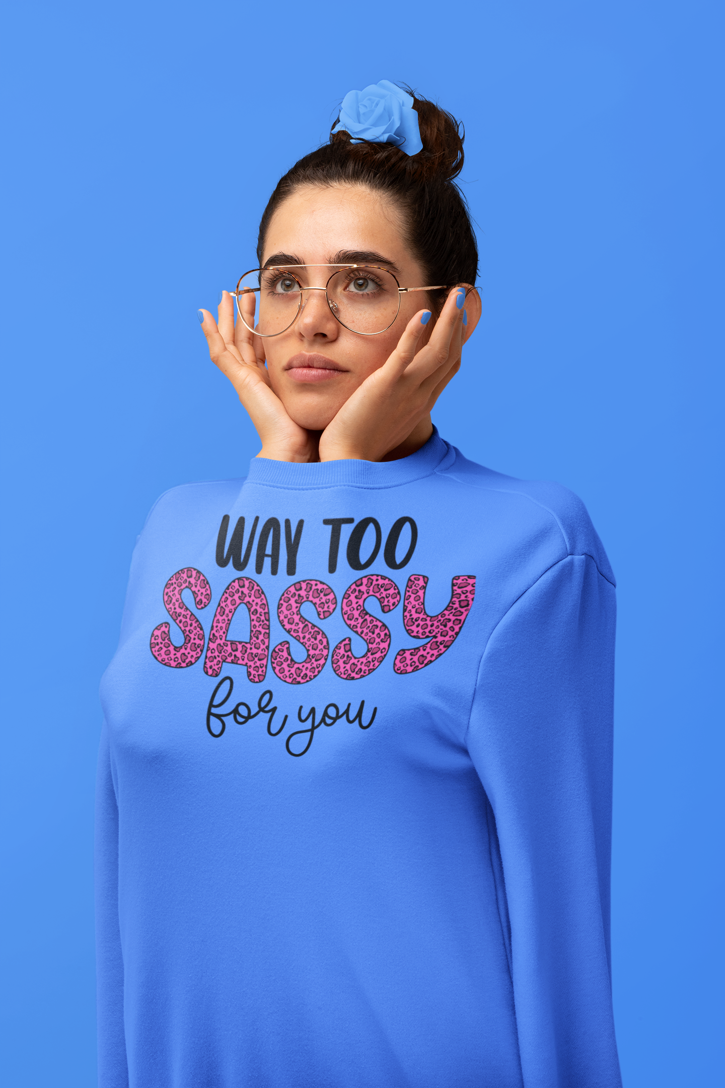 Woman wearing a blue sweatshirt with 'Way Too Sassy for You' text on a blue background