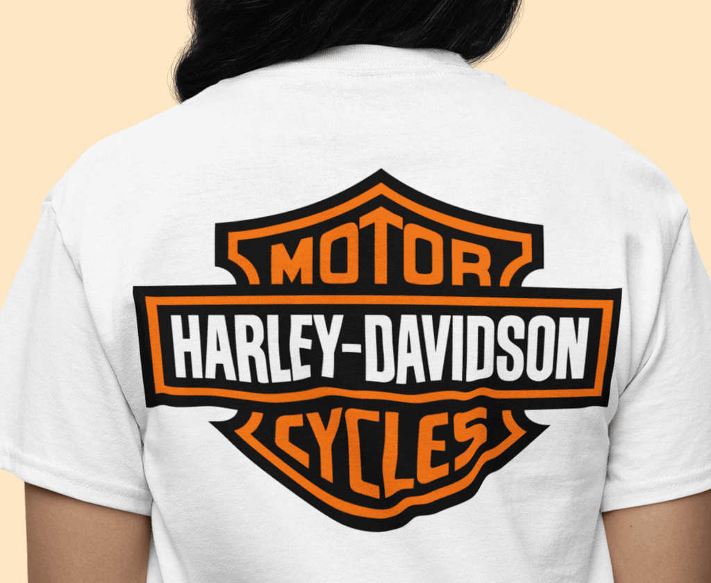 White t-shirt with Harley-Davidson logo on the back against a beige background