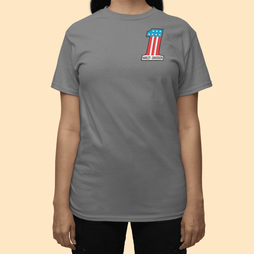 Person wearing a gray t-shirt with a logo on a beige background