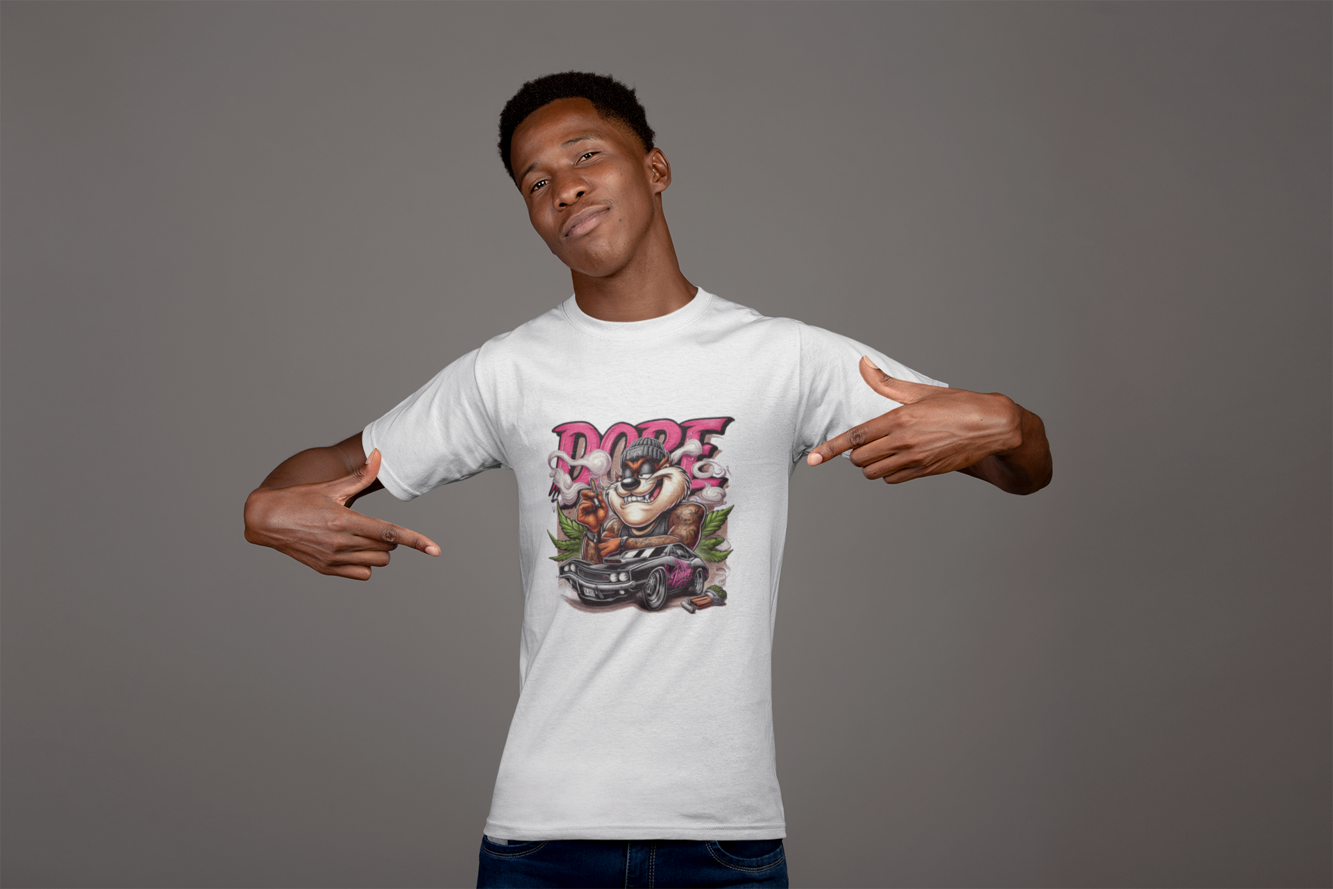 Man wearing a white t-shirt with a graphic design pointing to it against a gray background