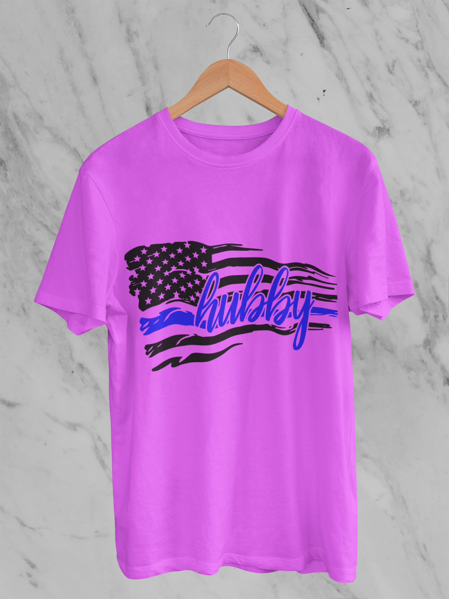 Pink t-shirt with American flag design and 'hulsey' text on a marble background