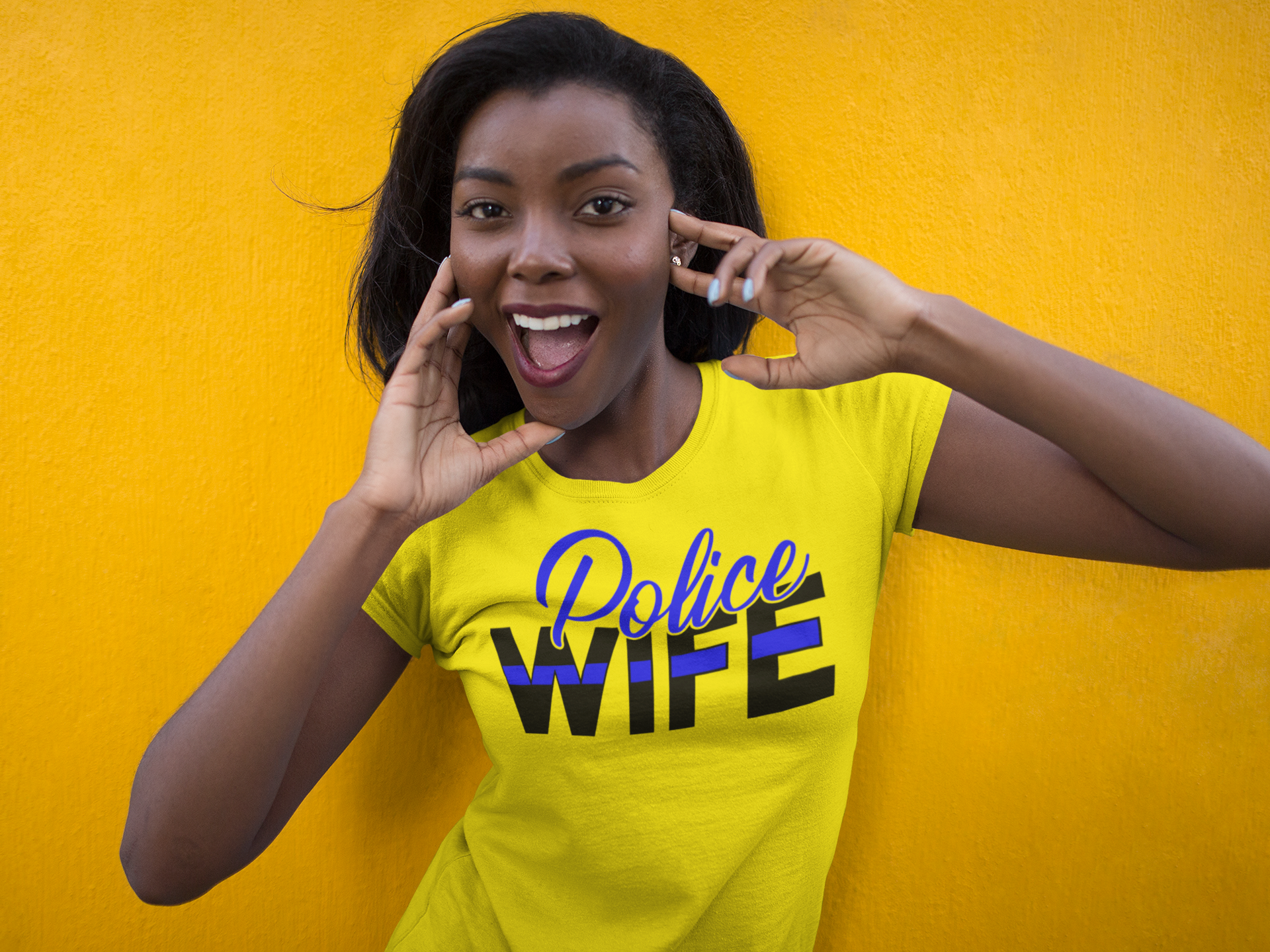 Woman wearing a yellow 'Police Wife' t-shirt against a yellow background