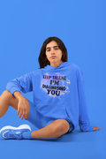 Person wearing a blue hoodie with text on a blue background