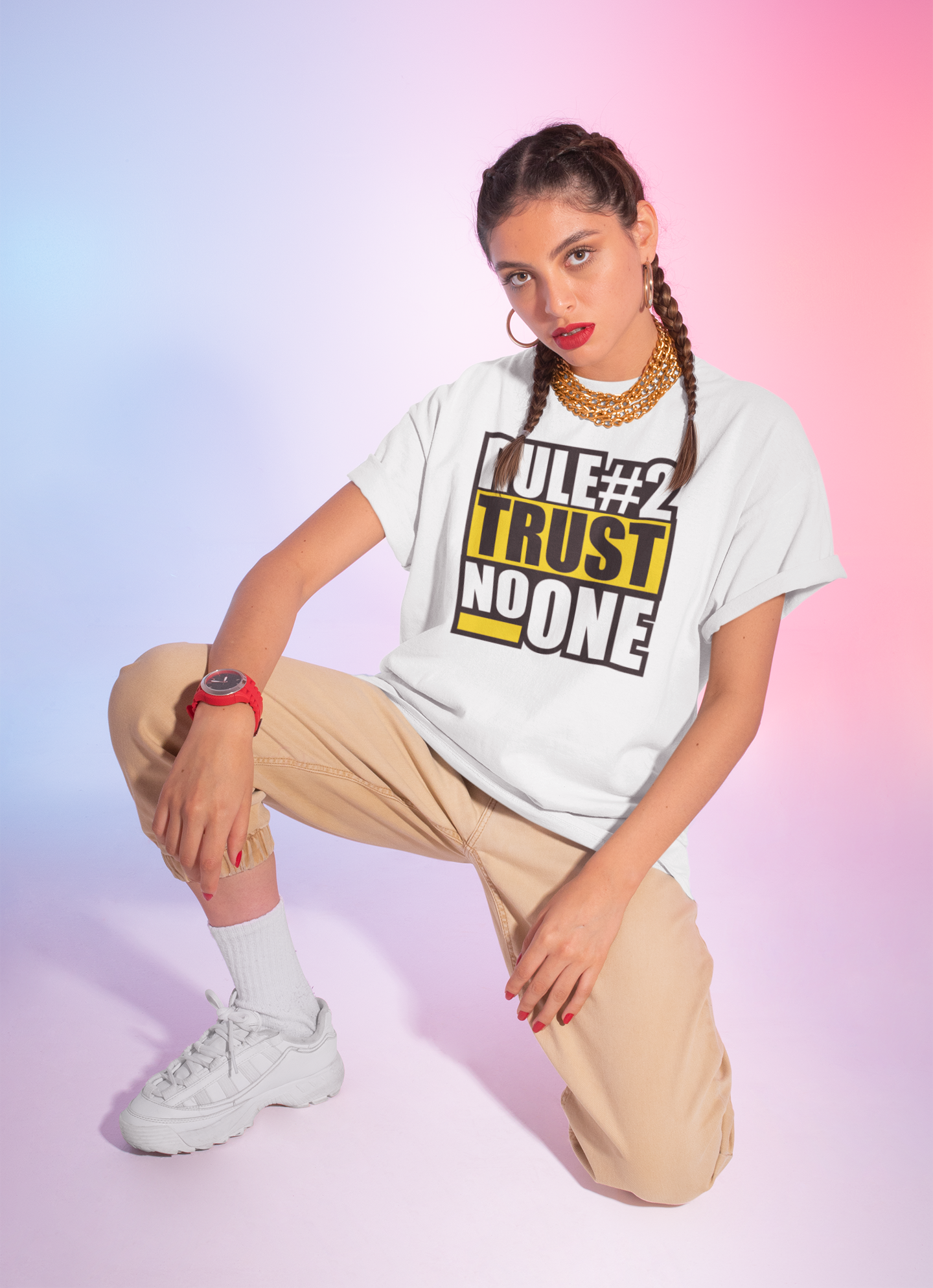 Person wearing a white t-shirt with text, beige pants, and white sneakers on a gradient background