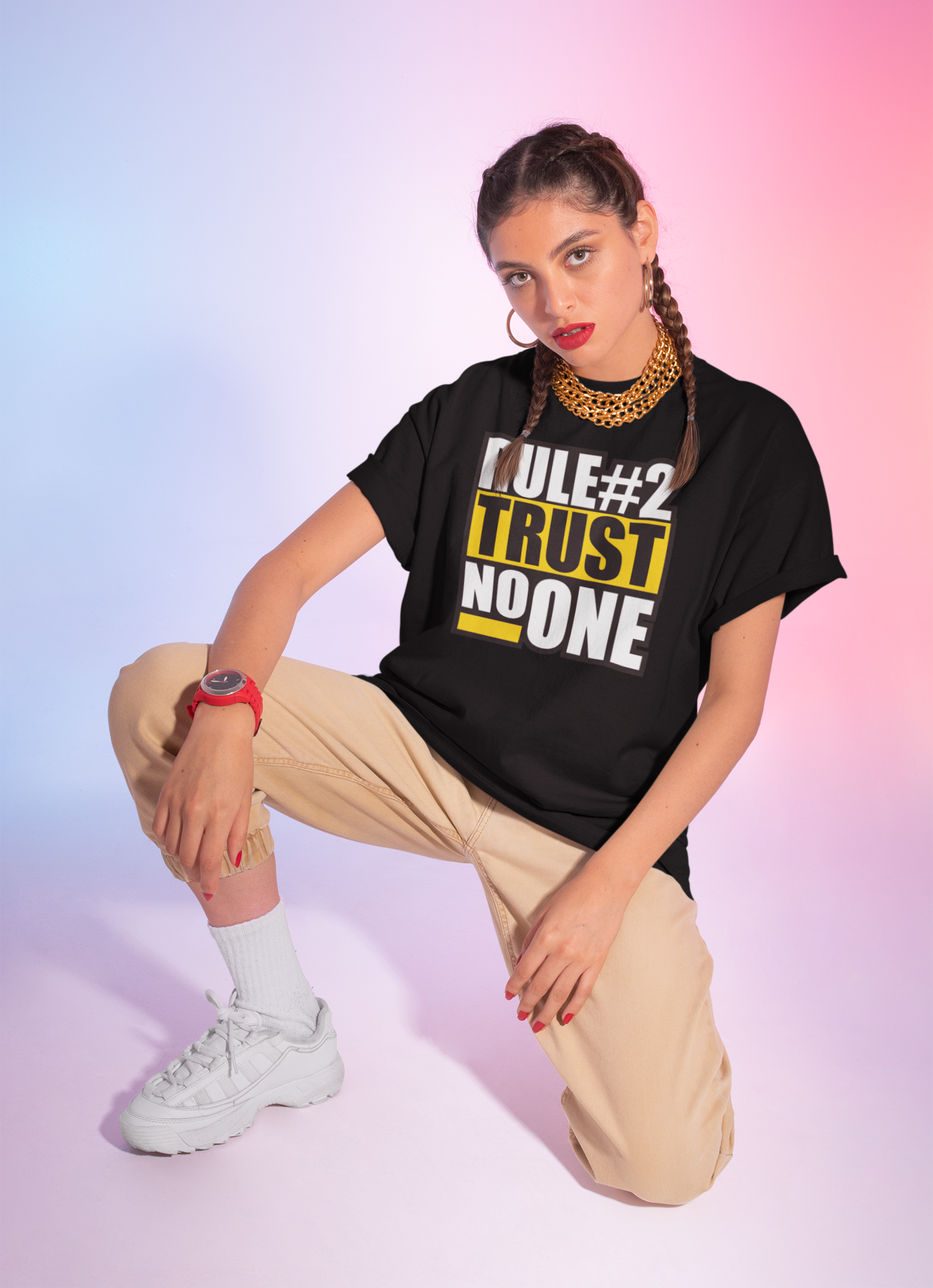 Woman wearing a black t-shirt with text, posing on a gradient background