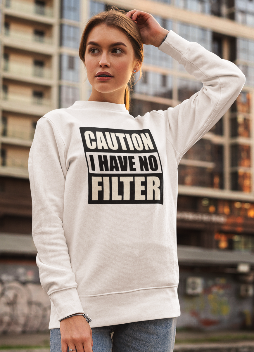 Woman wearing a white hoodie with 'CAUTION I HAVE NO FILTER' text in an urban setting