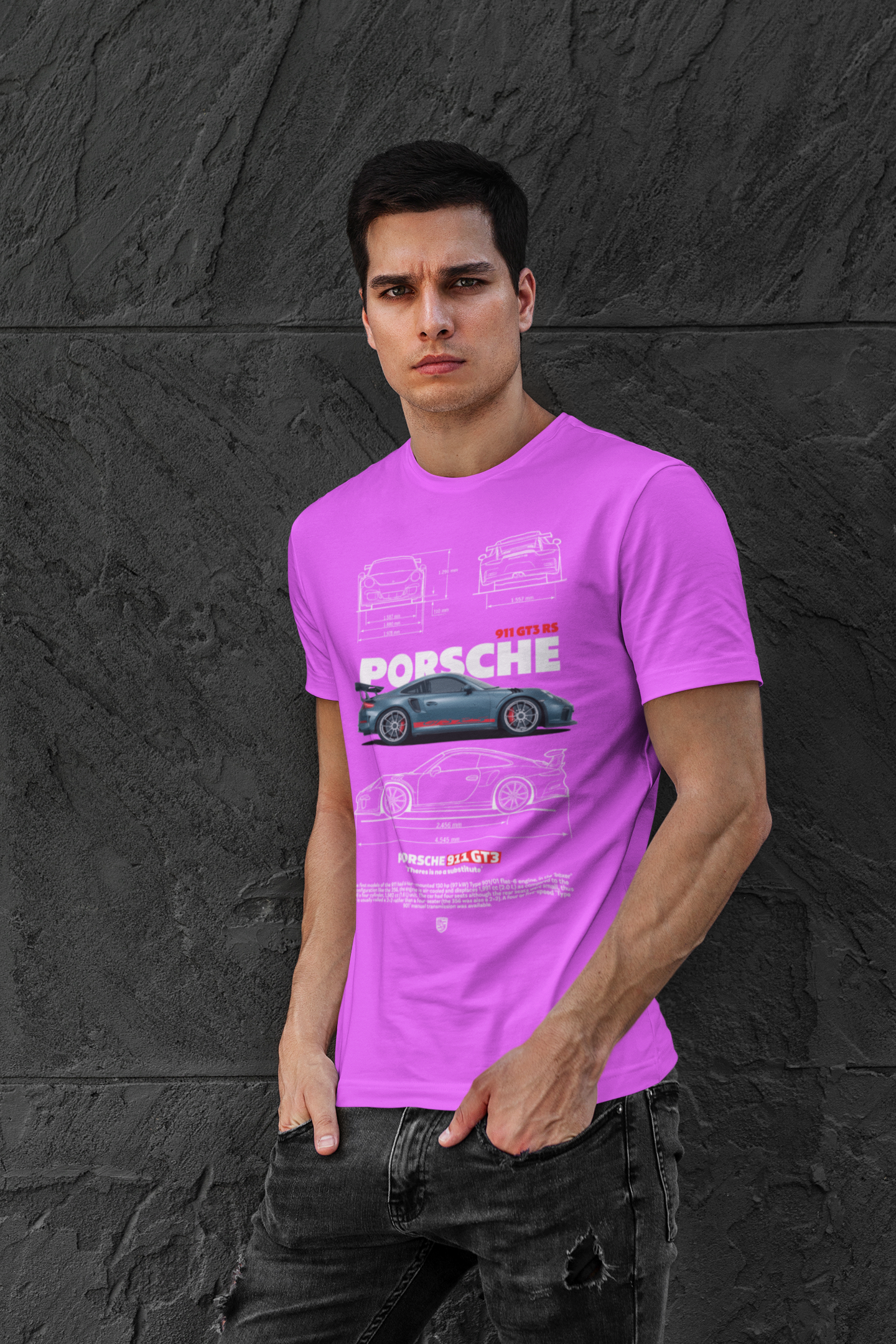 Person wearing a pink  t-shirt with Porsche logo against a black stone wall