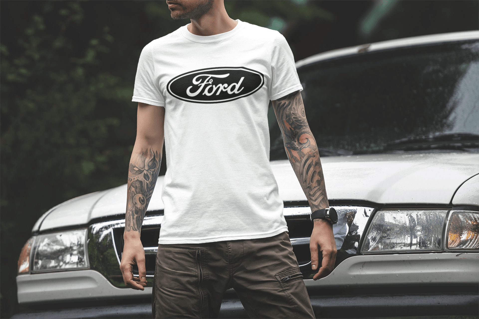 Person wearing a white Ford t-shirt standing in front of a car.