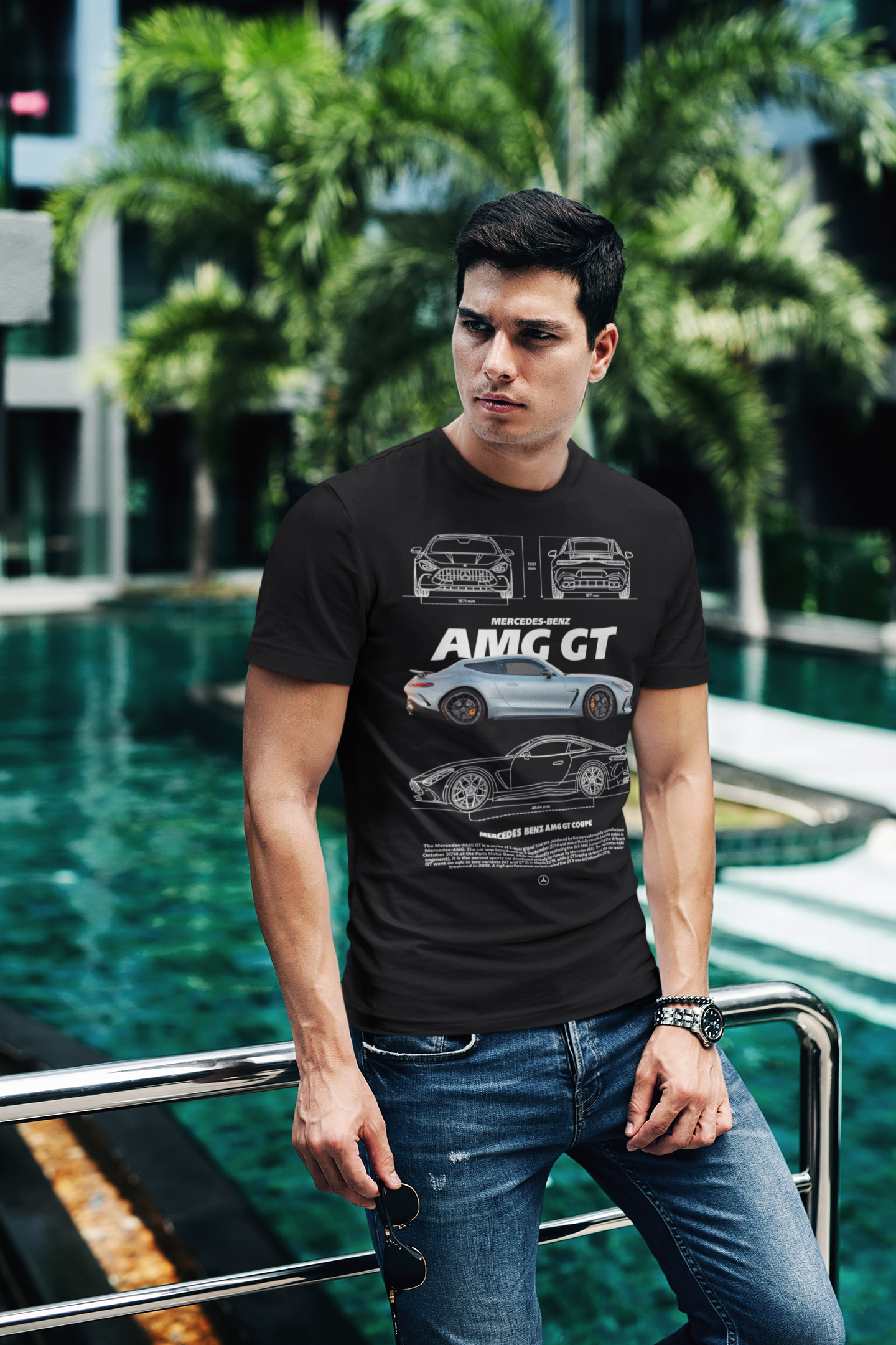 Man wearing a black t-shirt with car graphics by a pool
