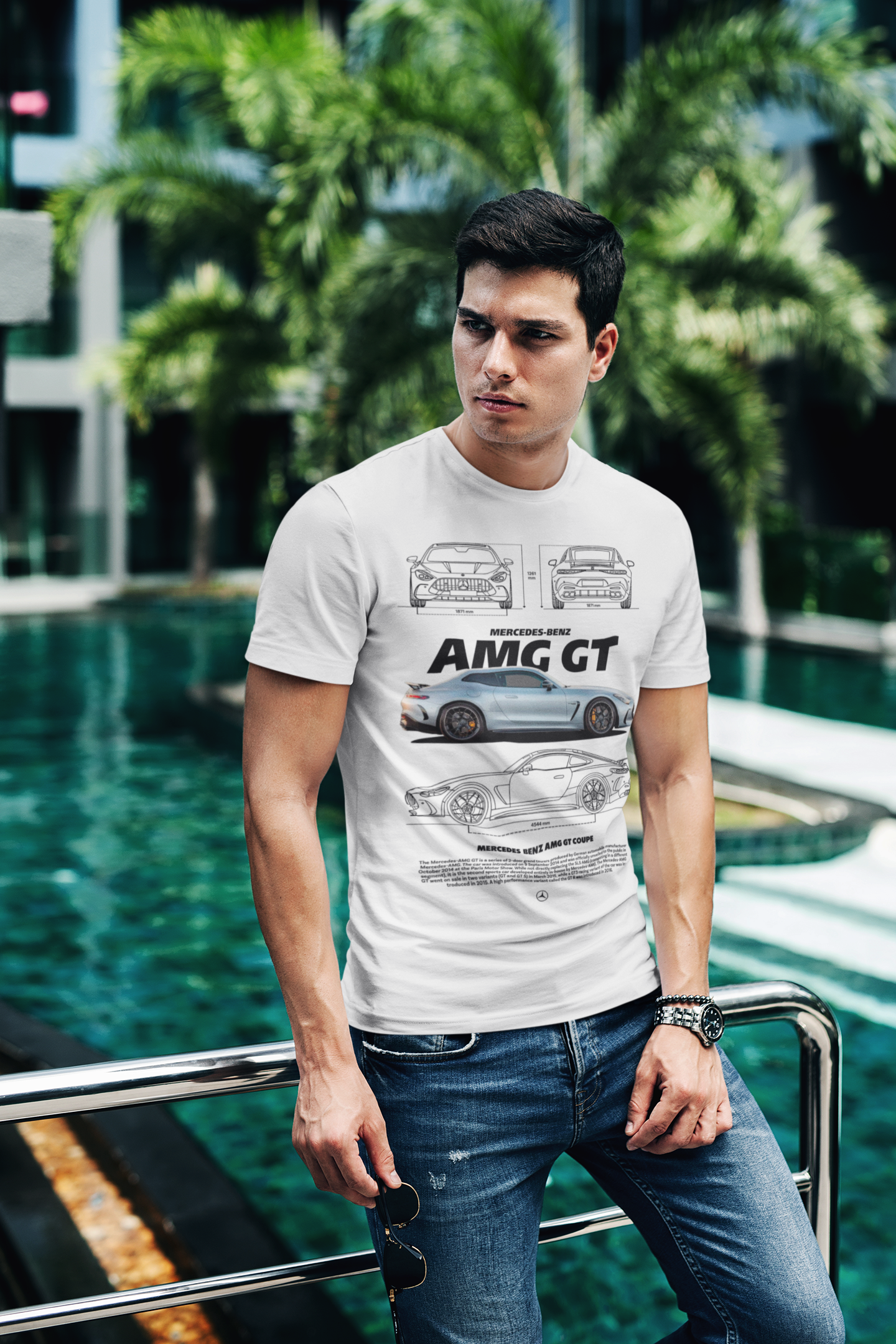 Man wearing a white t-shirt with car design standing by a pool