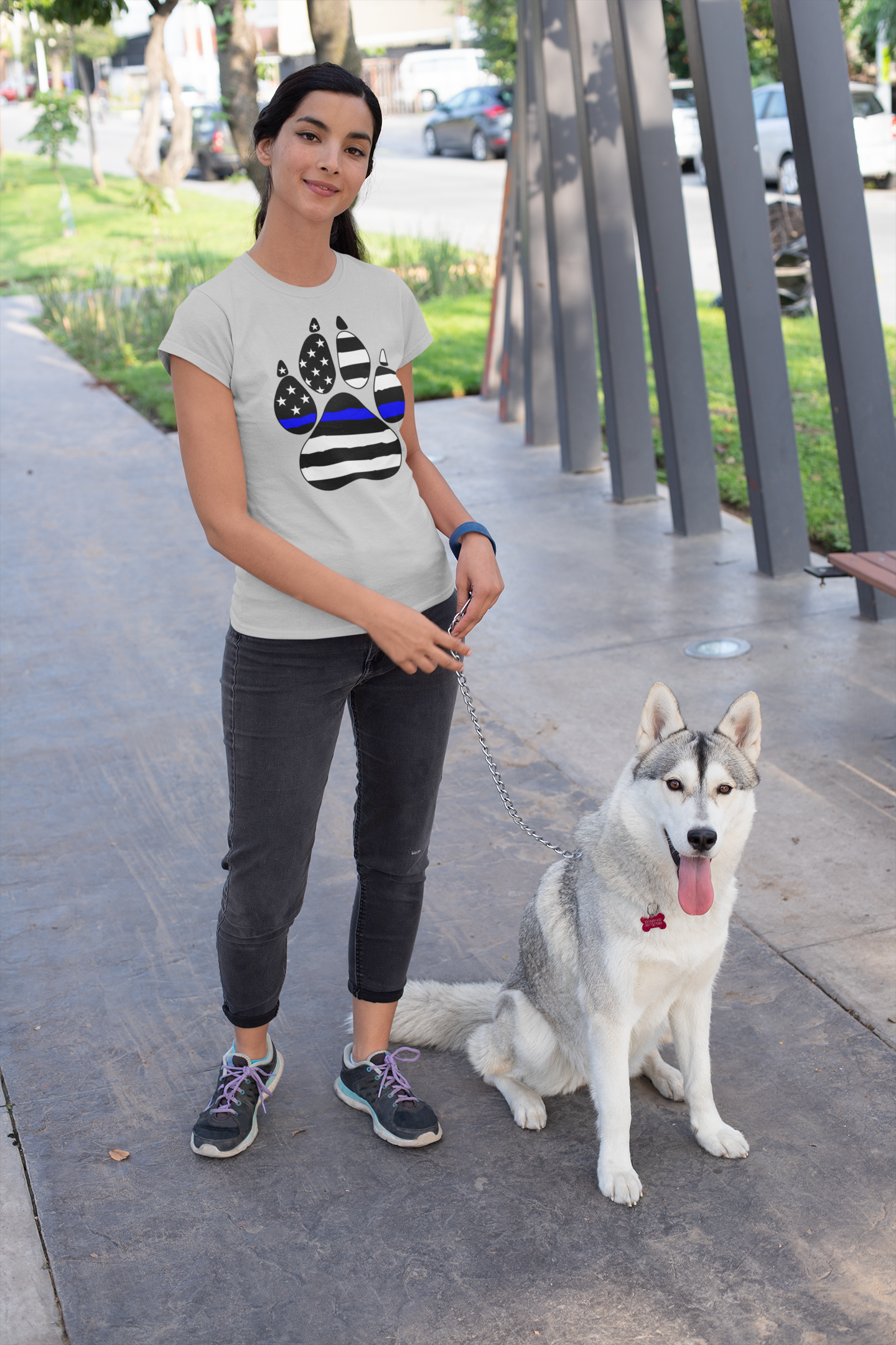 Woman walking a dog on a leash in an urban setting
